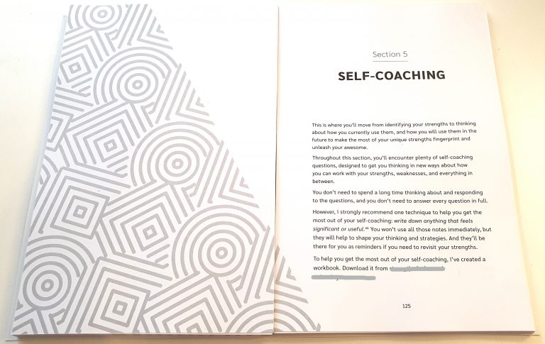 A photograph of a two-page spread from Unleash Your Awesome. The pages visible are the first two pages of Section 5 'Self Coaching'.