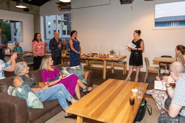 People listening to a book reading; the author is on the right-hand side of the photo