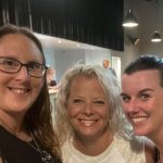 Three women smiling at the camera in a selfie